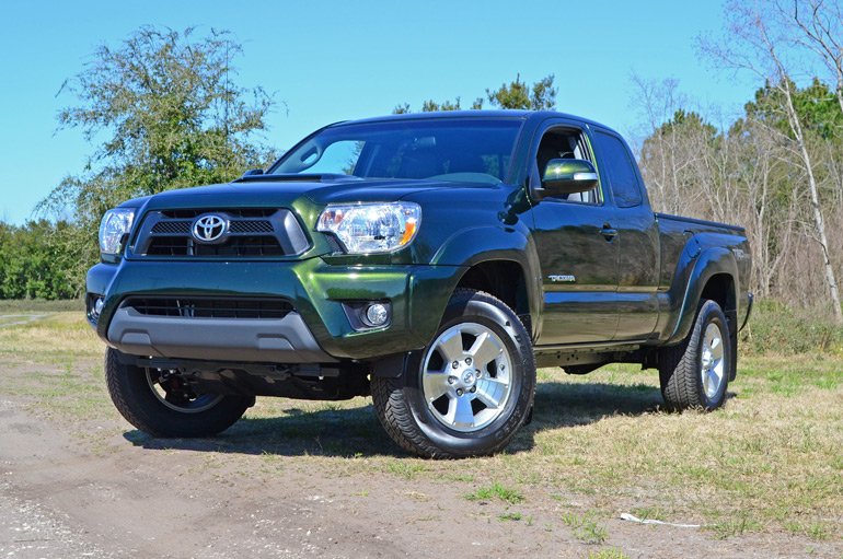 Green 2014 Toyota Tacoma Access Cab, a classic 2nd-gen model representing a stable period in the Toyota Tacoma years production.