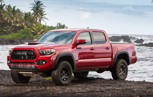 Front three-quarter view of a 2017 Toyota Tacoma TRD, a key model highlighting the Toyota Tacoma years of the modern third-generation platform with aggressive black styling.