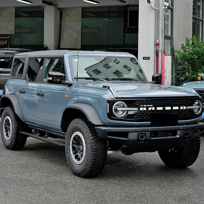 Front and side profile of a blue Ford Bronco SUV equipped with sturdy ford bronco running boards.