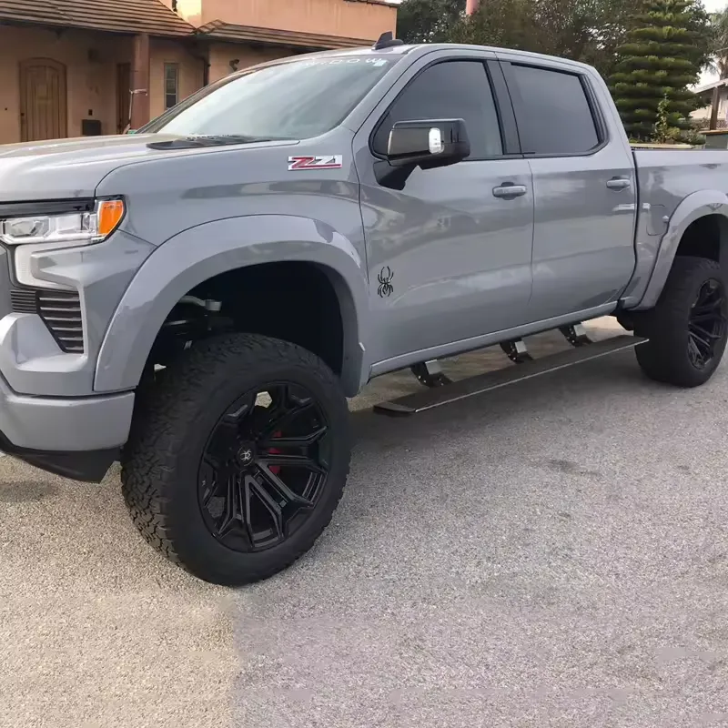 Street-side exterior view of a gray truck featuring Chevy Silverado Power Running Boards.