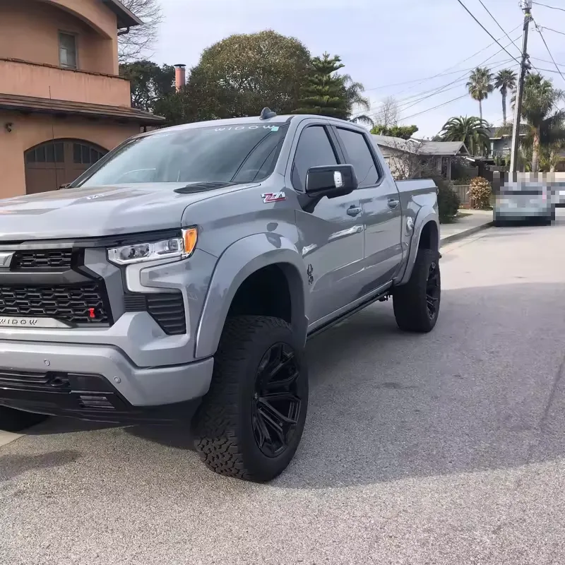 Street-side exterior view of a gray truck featuring Chevy Silverado Power Running Boards.