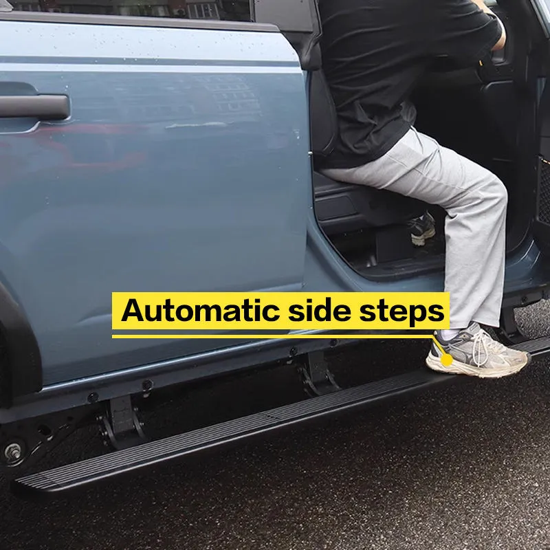 A person stepping onto automatic side steps, showcasing the practical use of ford bronco running boards.