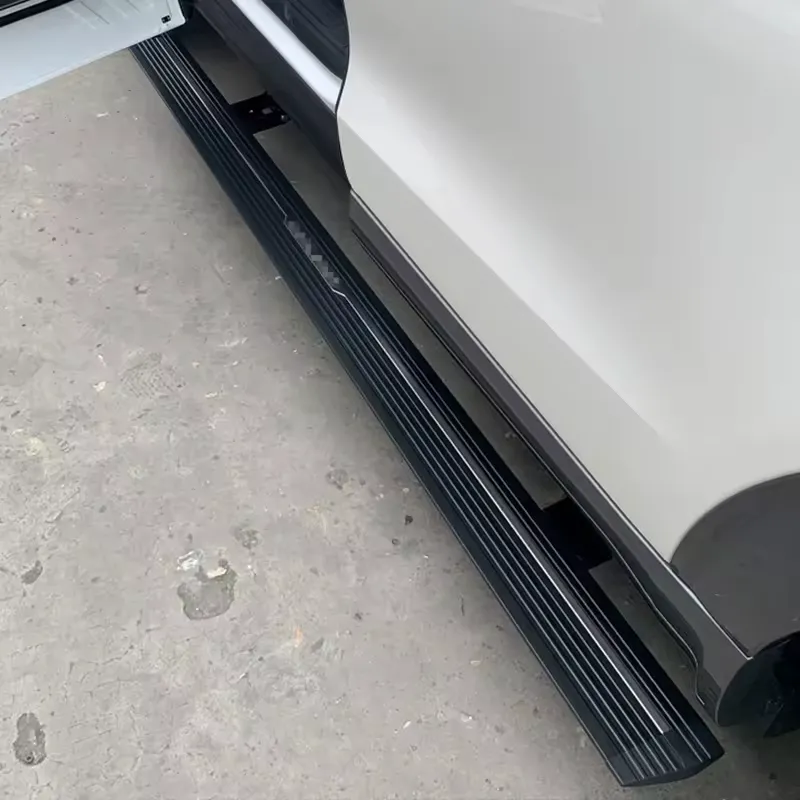 Nissan Patrol automatic running boards installed along the side of a white SUV