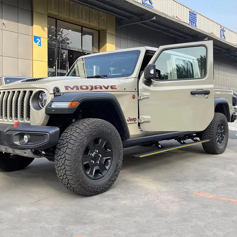 Front three-quarter angle of a beige Jeep Gladiator Mojave with power jeep gladiator running boards extended down.