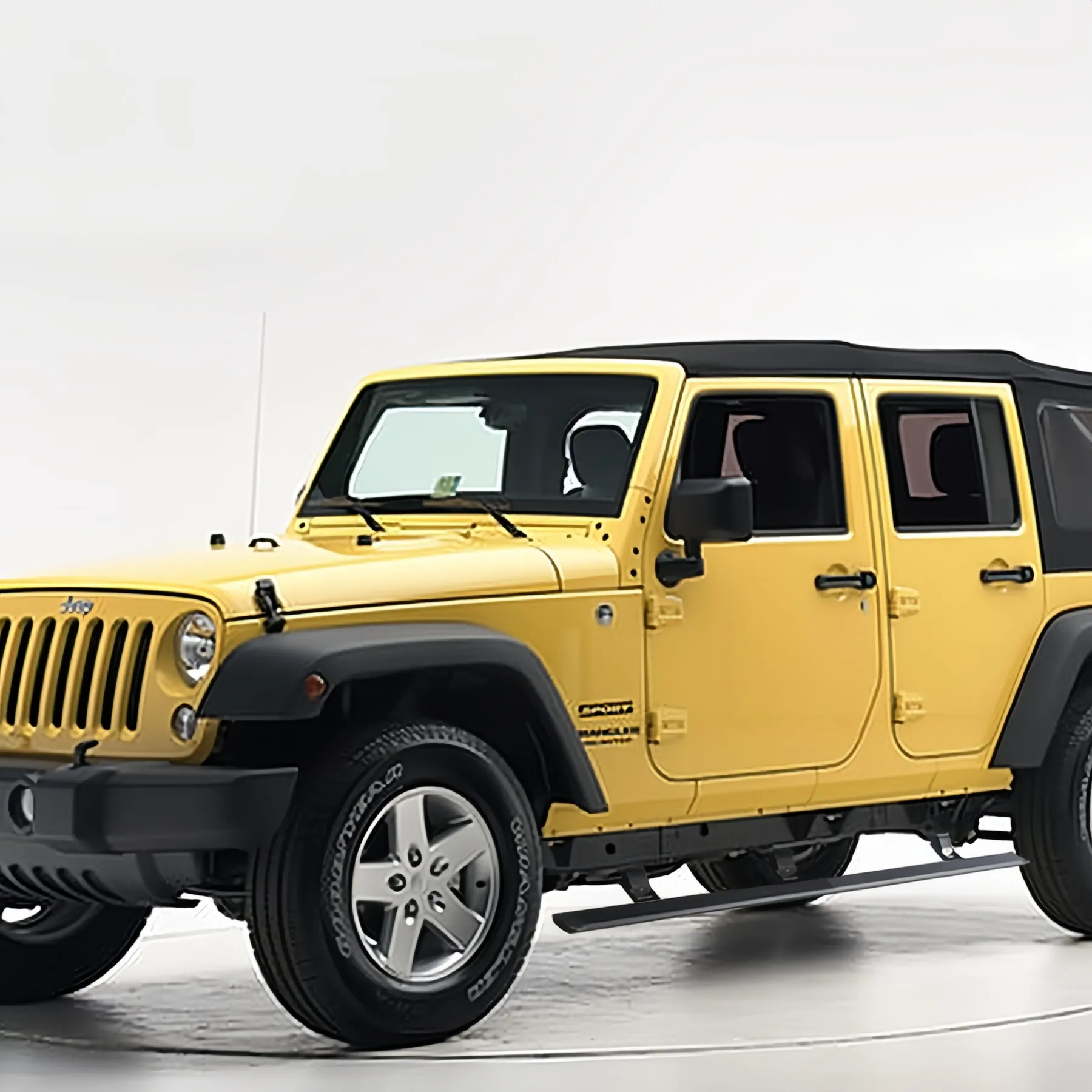 Electric power jeep jk running boards installed on a yellow 4-door Wrangler Unlimited