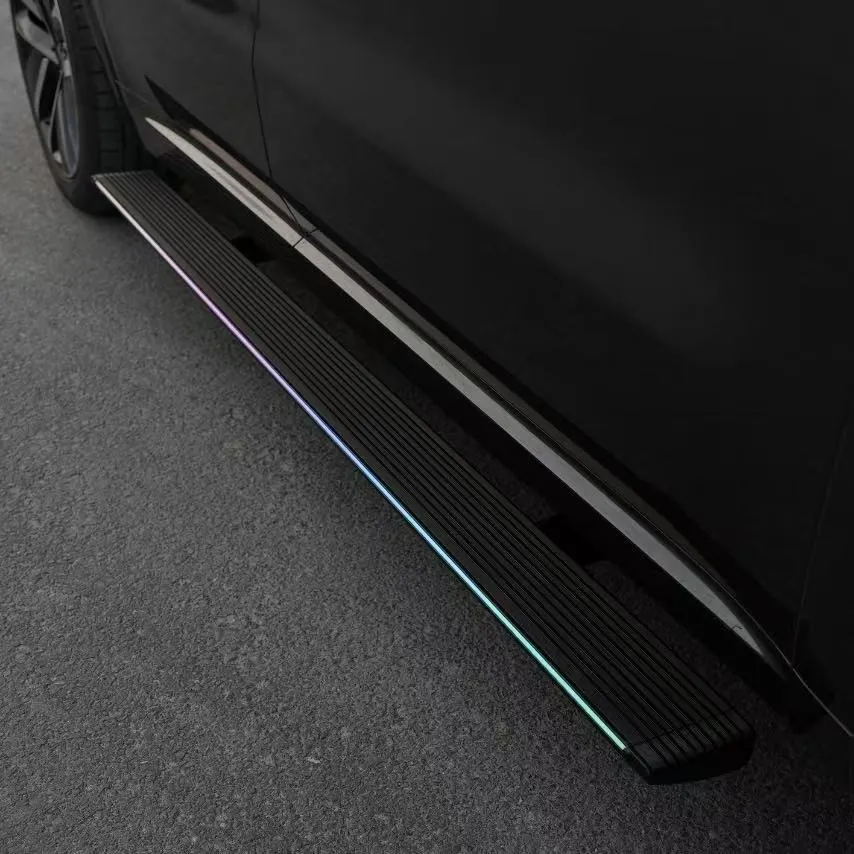 Close-up of power Nissan Frontier Running Boards featuring an integrated LED illumination strip along the step edge.