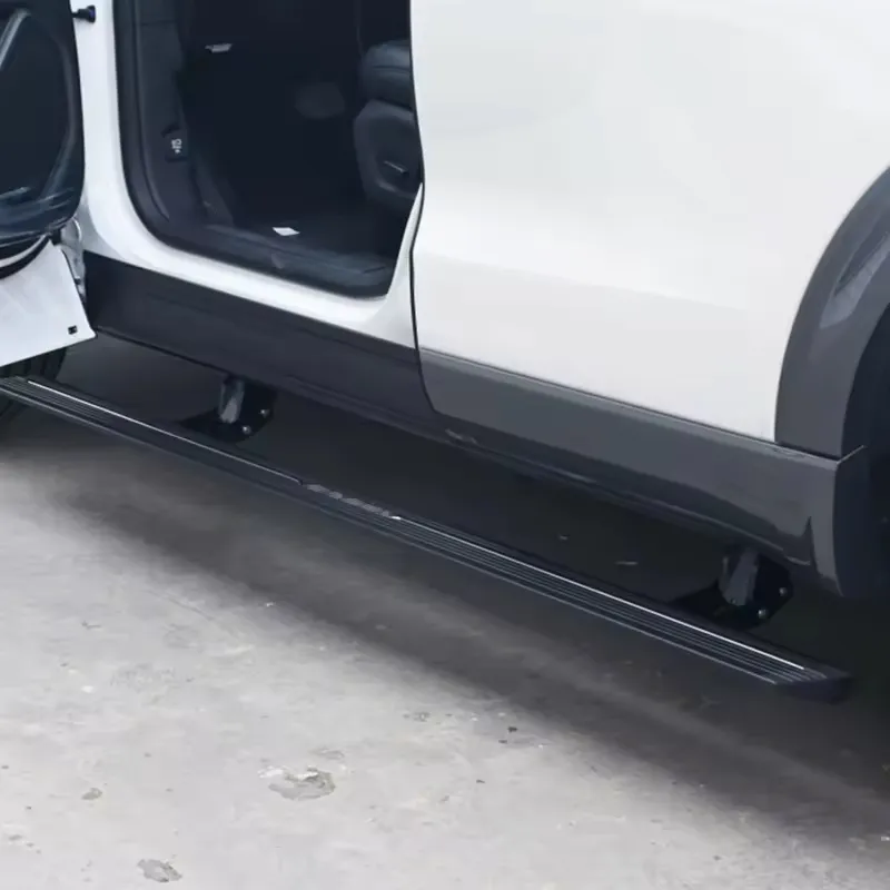 Retractable running boards fully deployed on a white Nissan Patrol Y63 SUV