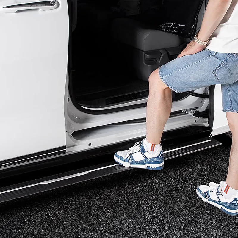 Passenger stepping onto extended Toyota Sienna running boards to enter the van.