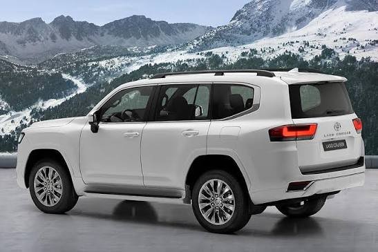 White Toyota Land Cruiser 300 Series (LC300) rear three-quarter view against a snowy mountain backdrop, representing an Electric Running Boards Manufacturer.