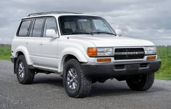 White Toyota Land Cruiser 80 Series (LC80) parked outdoors, representing a Power Running Boards Manufacturer.