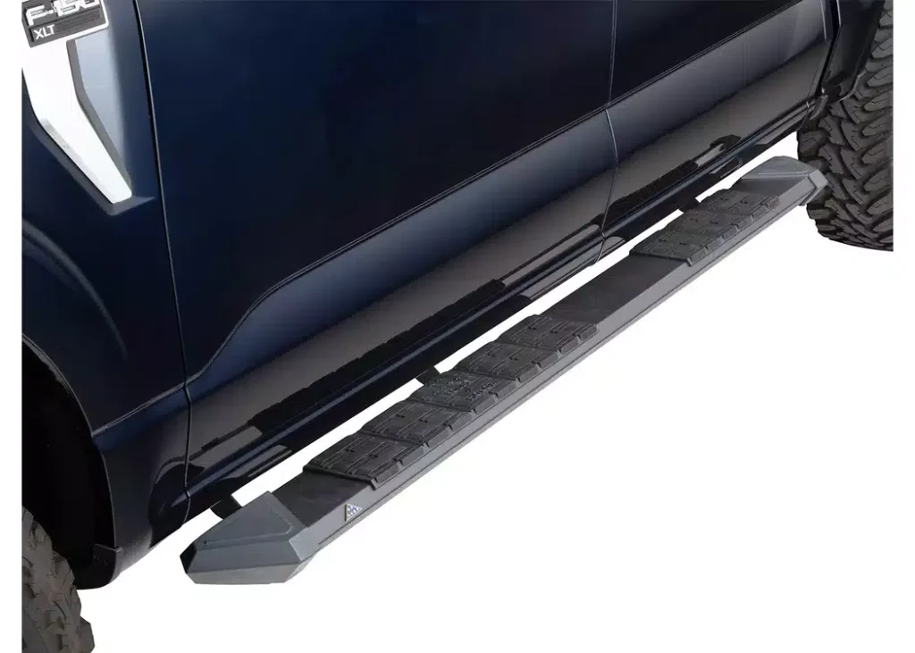 Side view of a dark blue Ford F-150 XLT pickup truck equipped with an extended black running board. This close-up highlights the heavy-duty Power Running Board Materials made of iron, featuring textured anti-slip step pads.