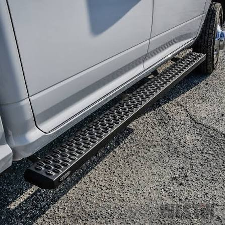 Black running boards mounted on a silver vehicle, featuring a perforated anti-slip step surface.