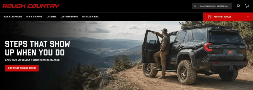 Rough Country website hero image showing an SUV on a mountain trail with power running boards, advertising a $100 discount. A major player among Electric Running Boards Manufacturers.