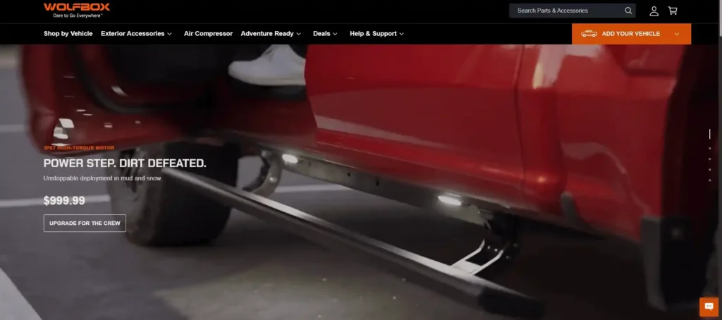 WOLFBOX Gear website homepage featuring a red truck with a deployed power step in muddy conditions, showcasing their IP67 high-torque motor running boards and their status as Electric Running Boards Manufacturers.