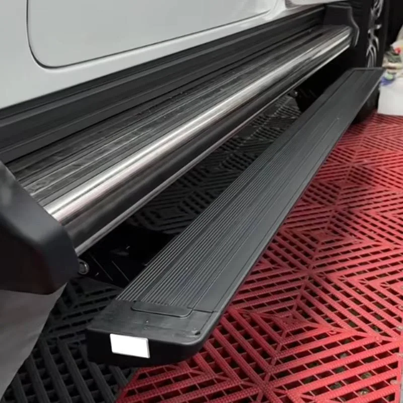 Close-up view of the textured anti-slip surface on the deployed Mercedes-Benz G550 Electric Running Boards, positioned beneath the factory side trim.