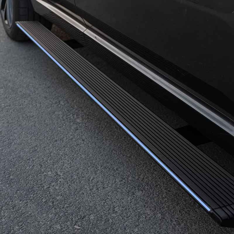 Close-up view of a fully deployed black Mercedes-Benz V-Class Electric Running Board featuring a bright blue LED light strip on the side.
