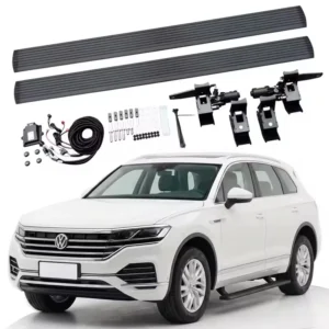 Complete Touareg electric side steps kit featuring running boards, motorized hinges, mounting brackets, wiring harness, and hardware displayed above a white Volkswagen Touareg SUV.