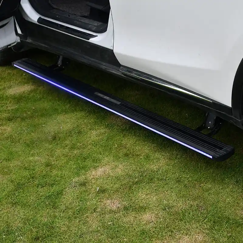 White SUV with the front door open, revealing the deployed BYD SEALION 6 Electric Side Steps with bright blue LED illumination on a grassy surface.
