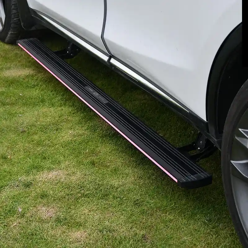 BYD SEALION 6 Electric Side Steps fully deployed on a white SUV with red LED illumination, parked on a grassy field.