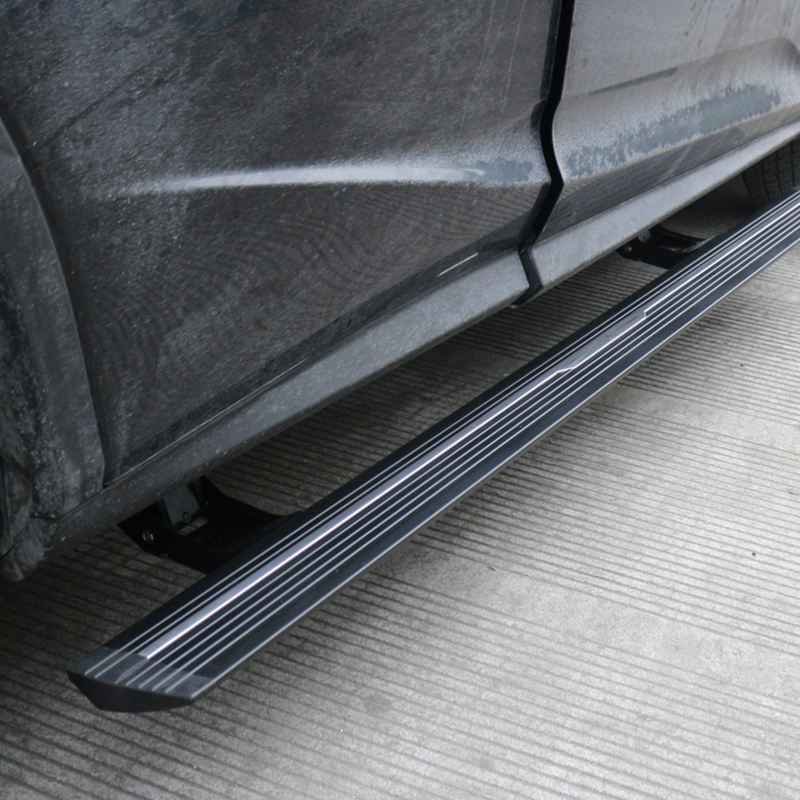 Close-up view of deployed lexus rx350 electric running boards on a dark vehicle parked on a paved surface.