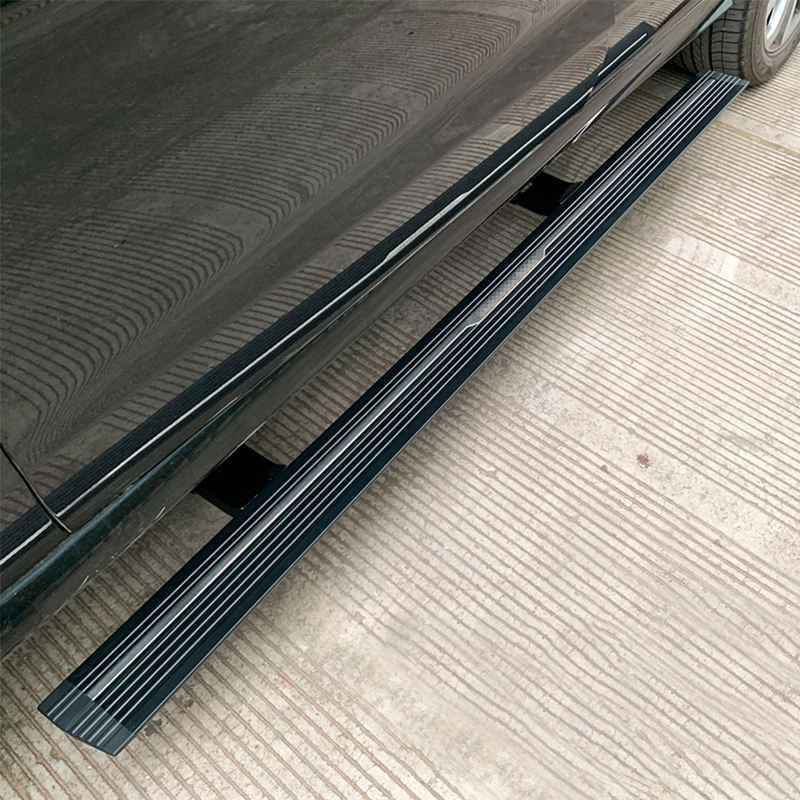 Close-up view of lexus rx450h electric running boards deployed on the side of a dark vehicle.