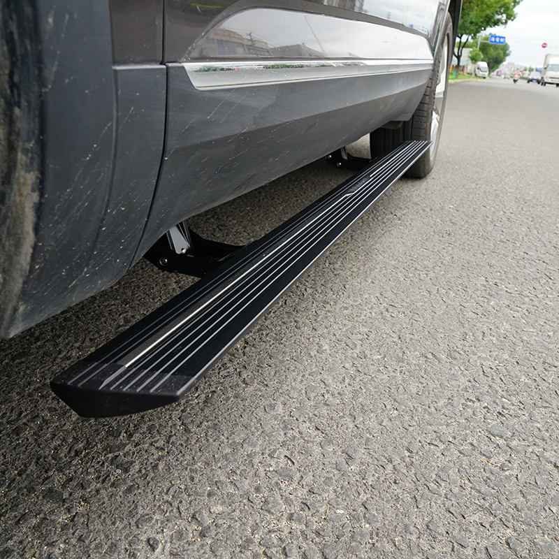 Low angle close-up of a vehicle on a paved road showing deployed lexus rx450h electric running boards.