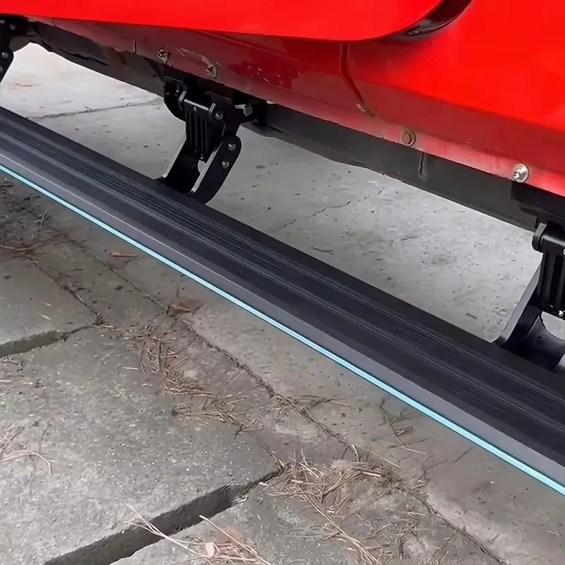 Close-up of Jeep Wrangler power running boards with a bright ice-blue LED light strip, heavy-duty linkage, and motor assembly.