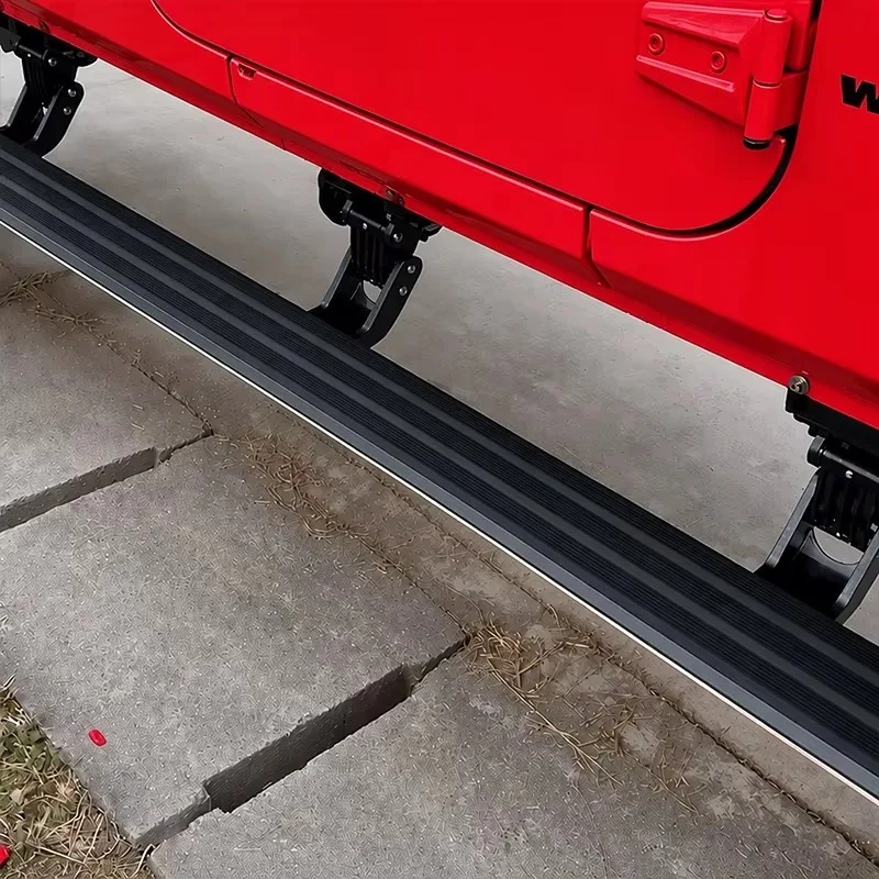 Detailed side view of Jeep Wrangler power running boards showing the black step surface, white LED strip, and folding bracket mechanism.
